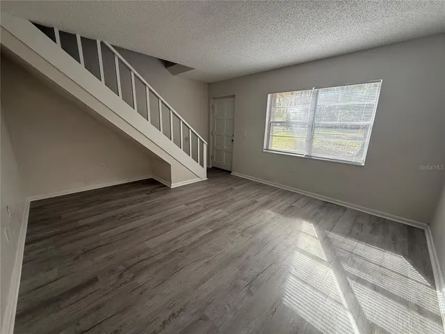 a view of an entryway with wooden floor