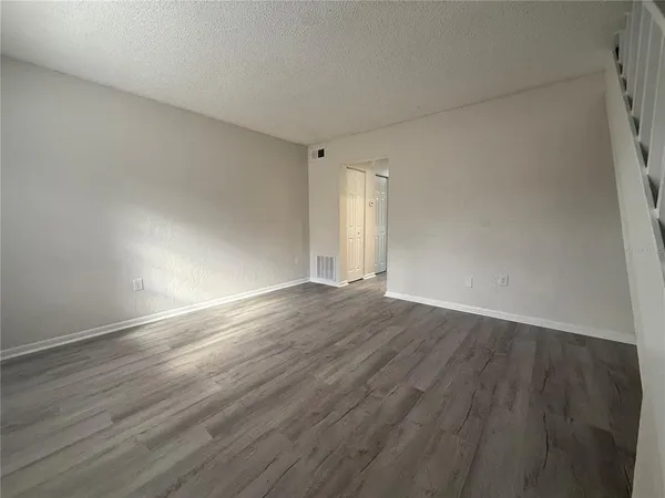 a view of an empty room and wooden floor
