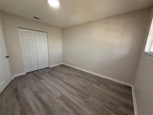 a view of a room with wooden floor
