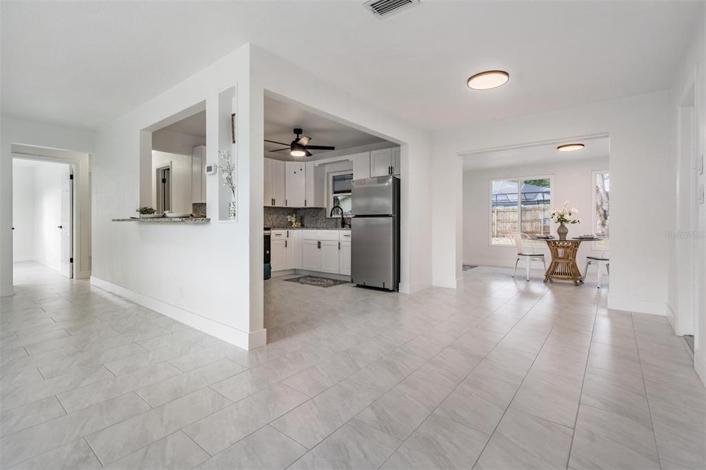 6472 113th Street Seminole, FL 33772 - Photo 14 of 36 a view of a living room and kitchen with furniture and a stove