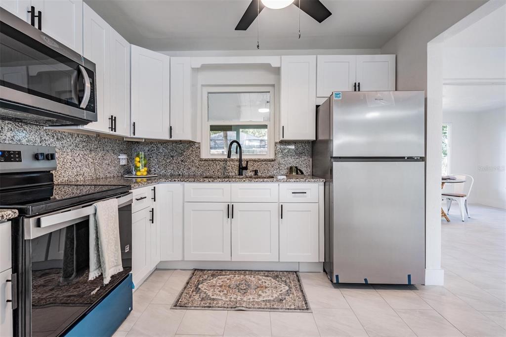 6472 113th Street Seminole, FL 33772 - Photo 19 of 36 a kitchen with a refrigerator sink and microwave