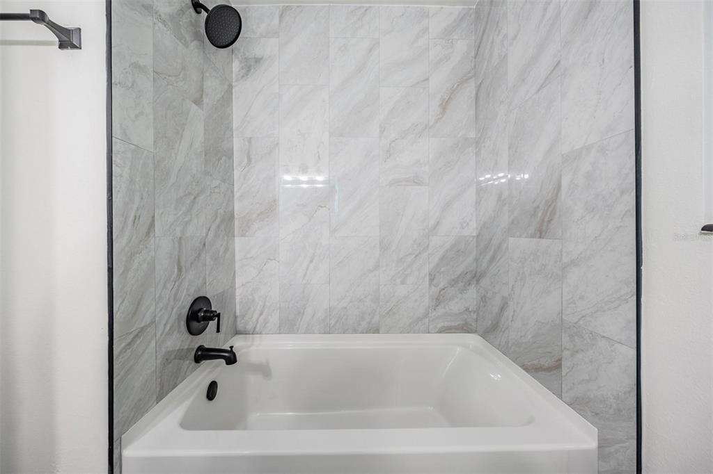 6472 113th Street Seminole, FL 33772 - Photo 23 of 36 a bathroom with a tub