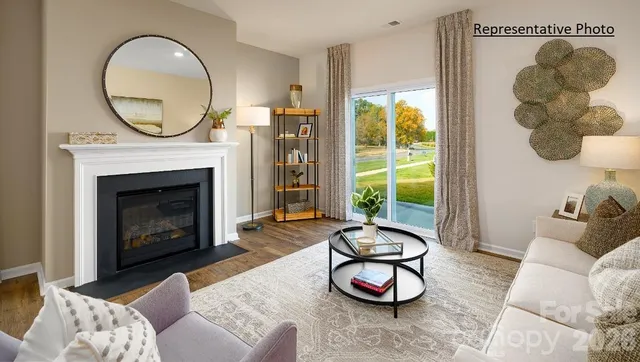 a living room with furniture a window and a fireplace