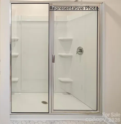 a bathroom with a glass shower door