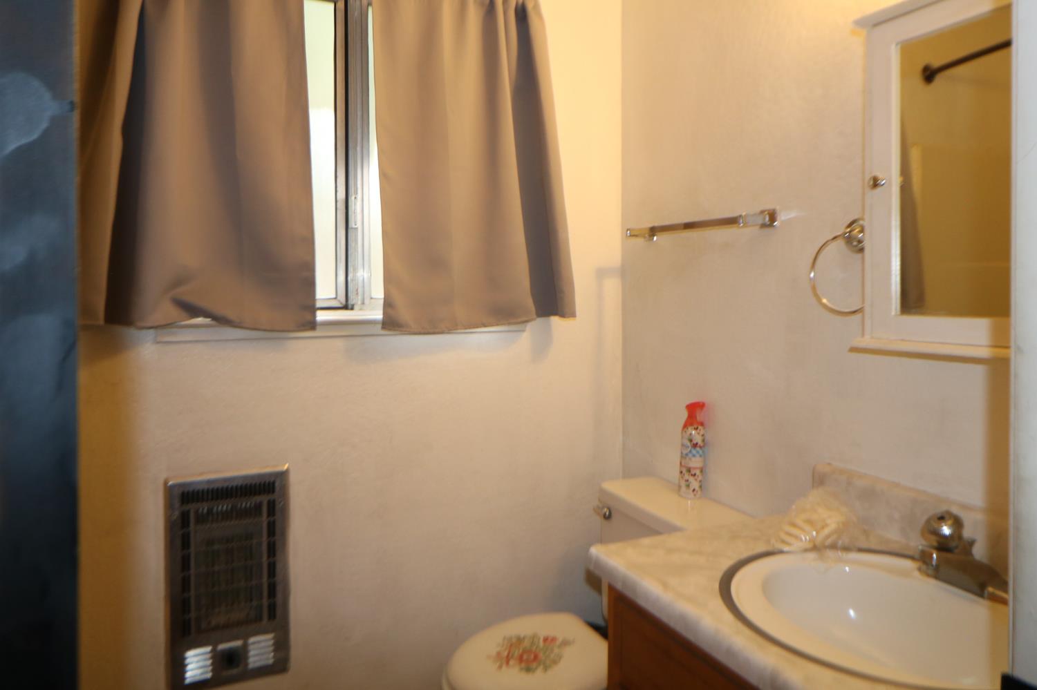 1536 Meadowview Road Arnold, CA 95223 - Photo 11 of 22 a bathroom with a sink toilet and mirror