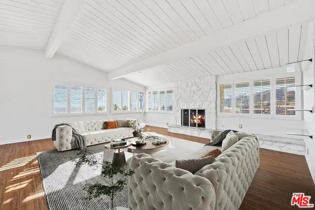 a living room with furniture a fireplace and a table