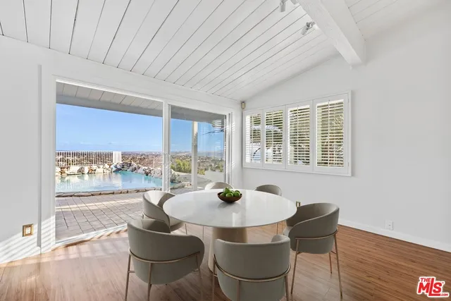 a dining room with furniture and wooden floor