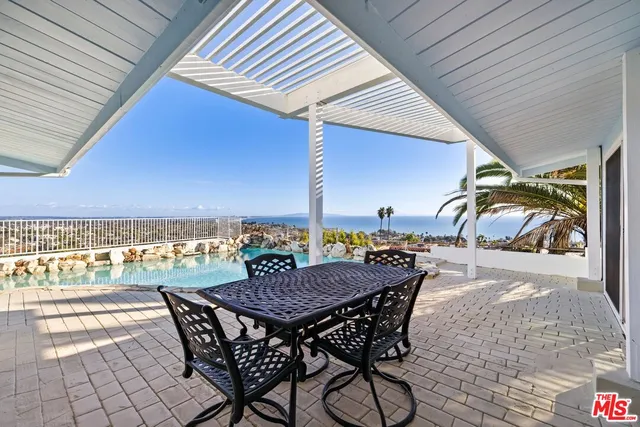 a view of a terrace with furniture and stove