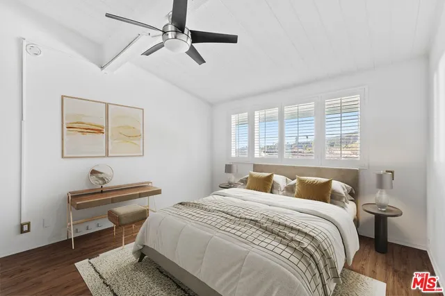 a bedroom with a bed and a desk