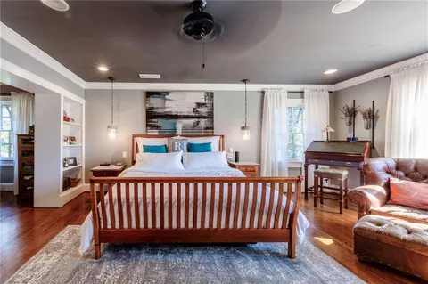 a bedroom with furniture and a wooden floor