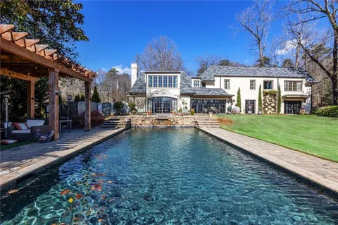 a view of a house with swimming pool patio and yard
