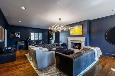 a living room with fireplace furniture and a flat screen tv