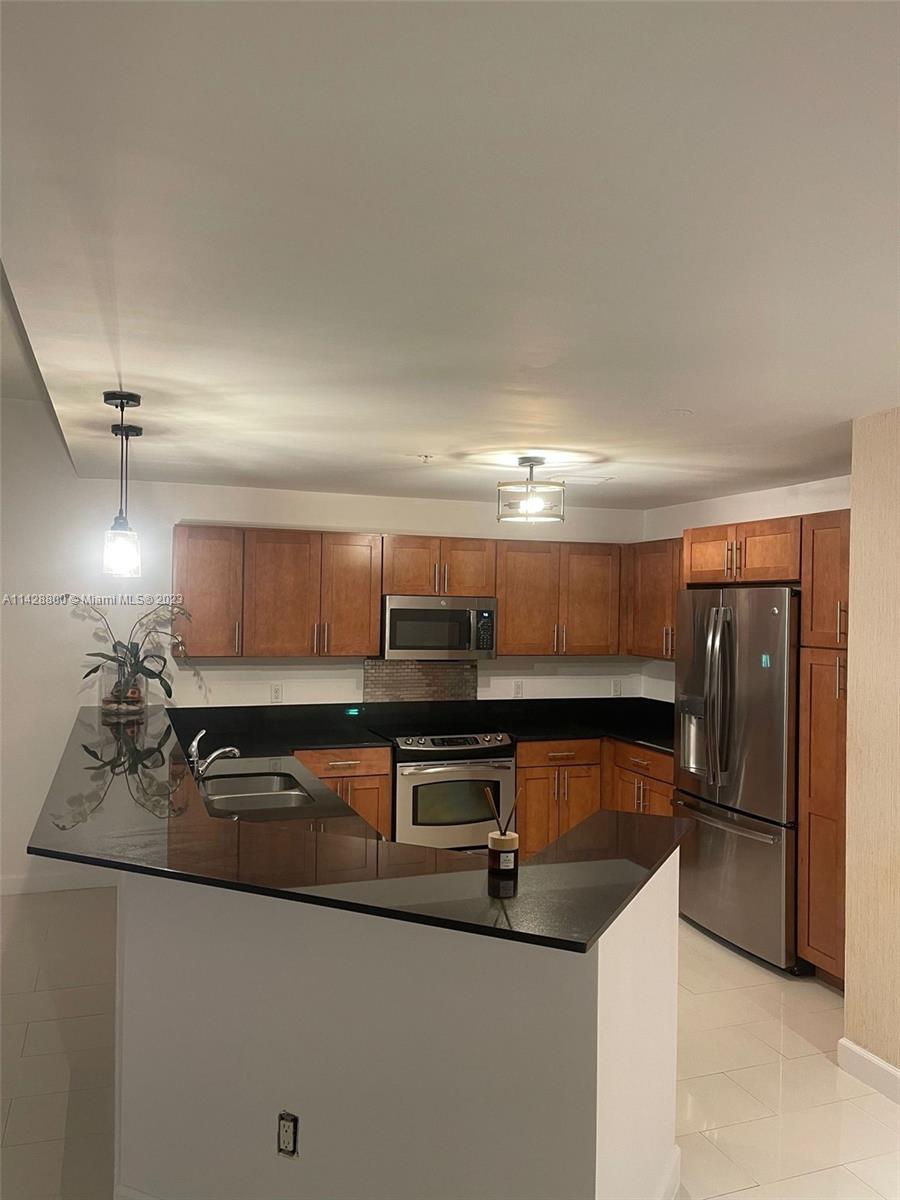 Se Colonnade at Dadeland Condominiums Miami, FL 33143 - Photo 6 of 32 a kitchen with kitchen island a sink stainless steel appliances and cabinets