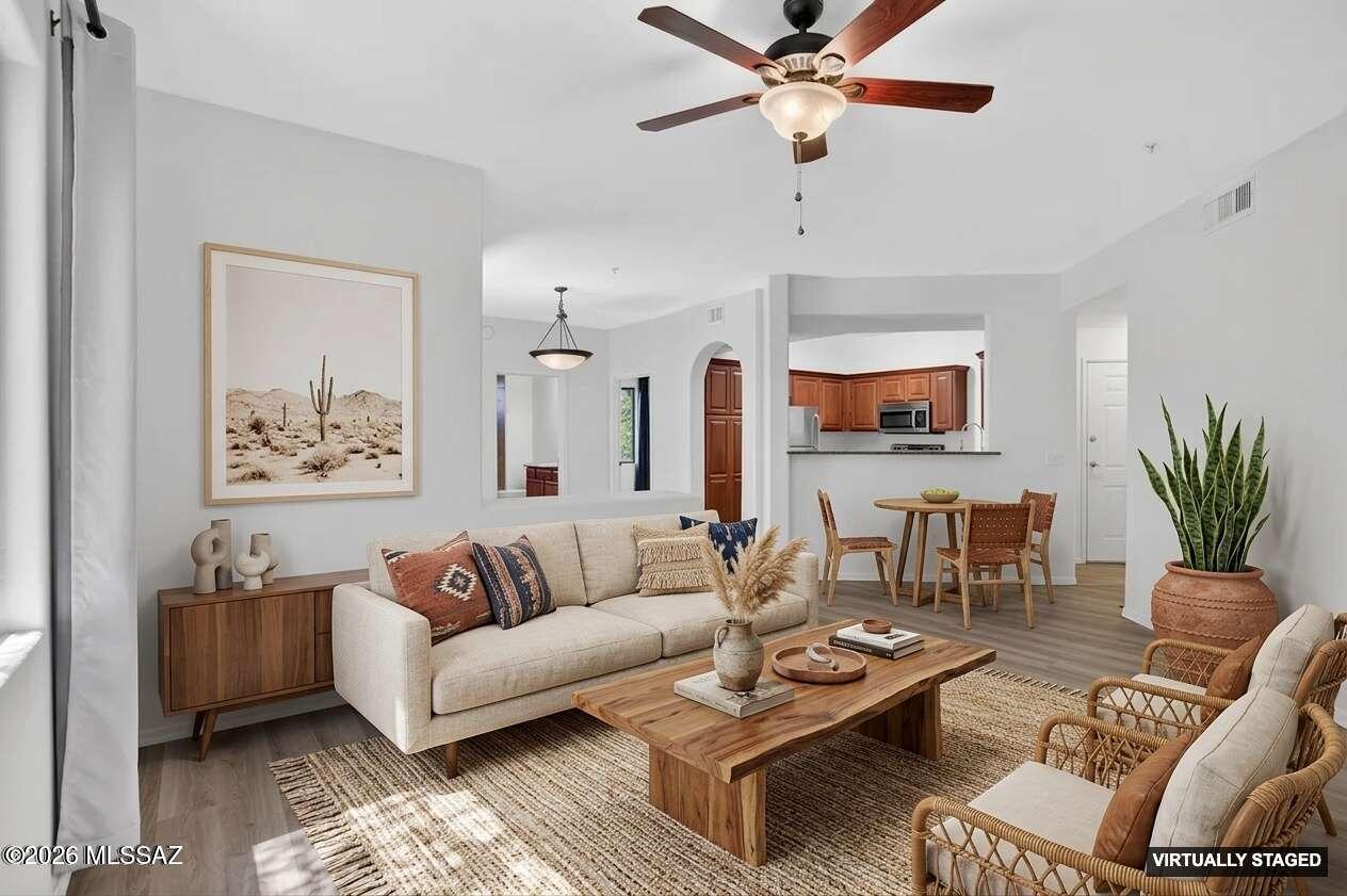 2550 East River Road, Unit 4204 Tucson, AZ 85718 - Photo 6 of 36 a living room with furniture a couch and a chandelier