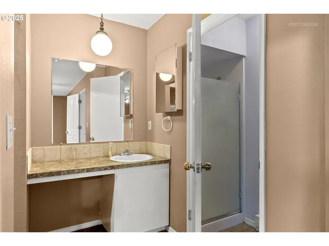 a bathroom with a sink and mirror