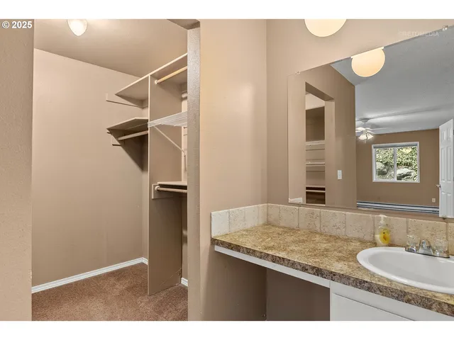 a bathroom with a granite countertop sink mirror and toilet