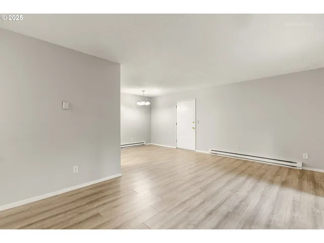 a view of an empty room and wooden floor