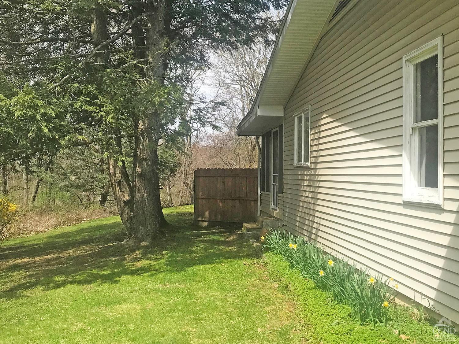 44 Benner Road Red Hook, NY 12571 - Photo 18 of 22 a view of a backyard with a tree