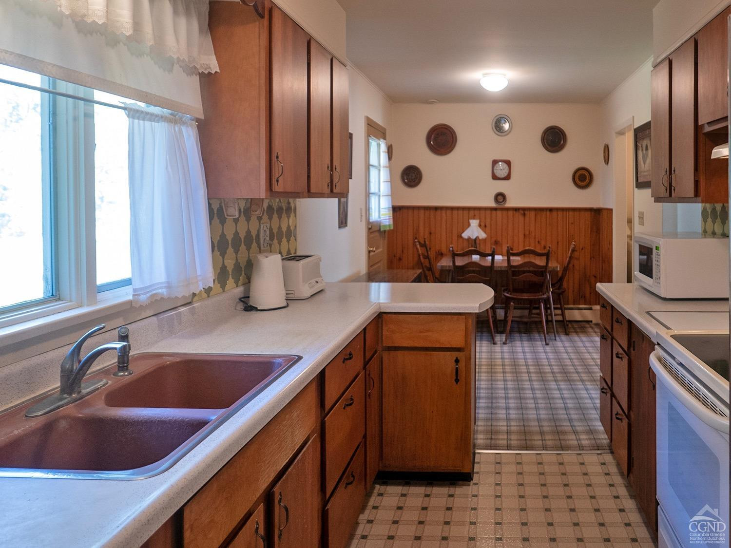 44 Benner Road Red Hook, NY 12571 - Photo 5 of 22 a kitchen with stainless steel appliances a sink a stove and a refrigerator