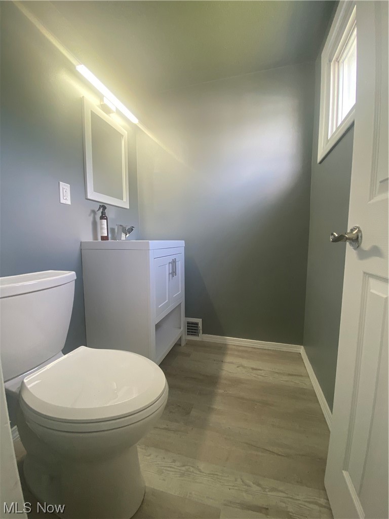 12913 Silver Road Cleveland, OH 44125 - Photo 16 of 23 2nd floor 1/2 Bathroom featuring vanity, mirror, and light hardwood flooring