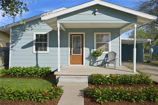 a front view of a house with garden
