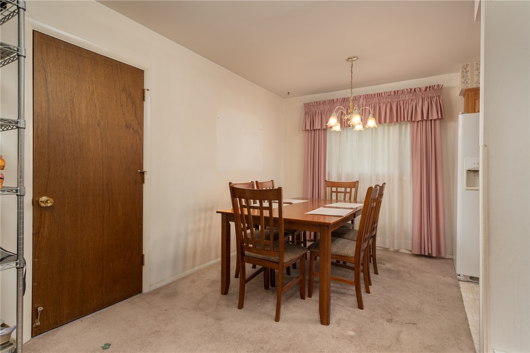 795 Spring Garden Place Dayton, OH 45431 - Photo 19 of 34 This cozy dining area features a classic chandelier and soft carpeting, perfect for intimate gatherings.