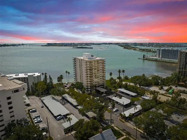 an aerial view of a city with lots of residential buildings lake and ocean view