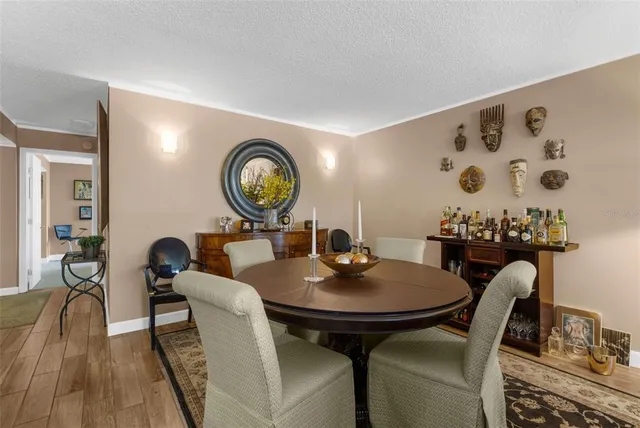a dining room with furniture and a mirror