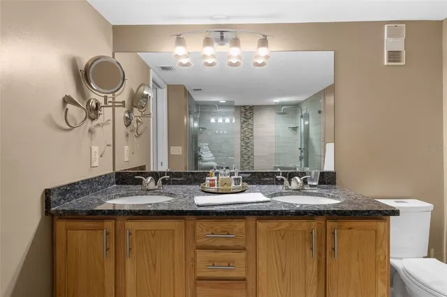 a spacious bedroom with a bed and a chandelier