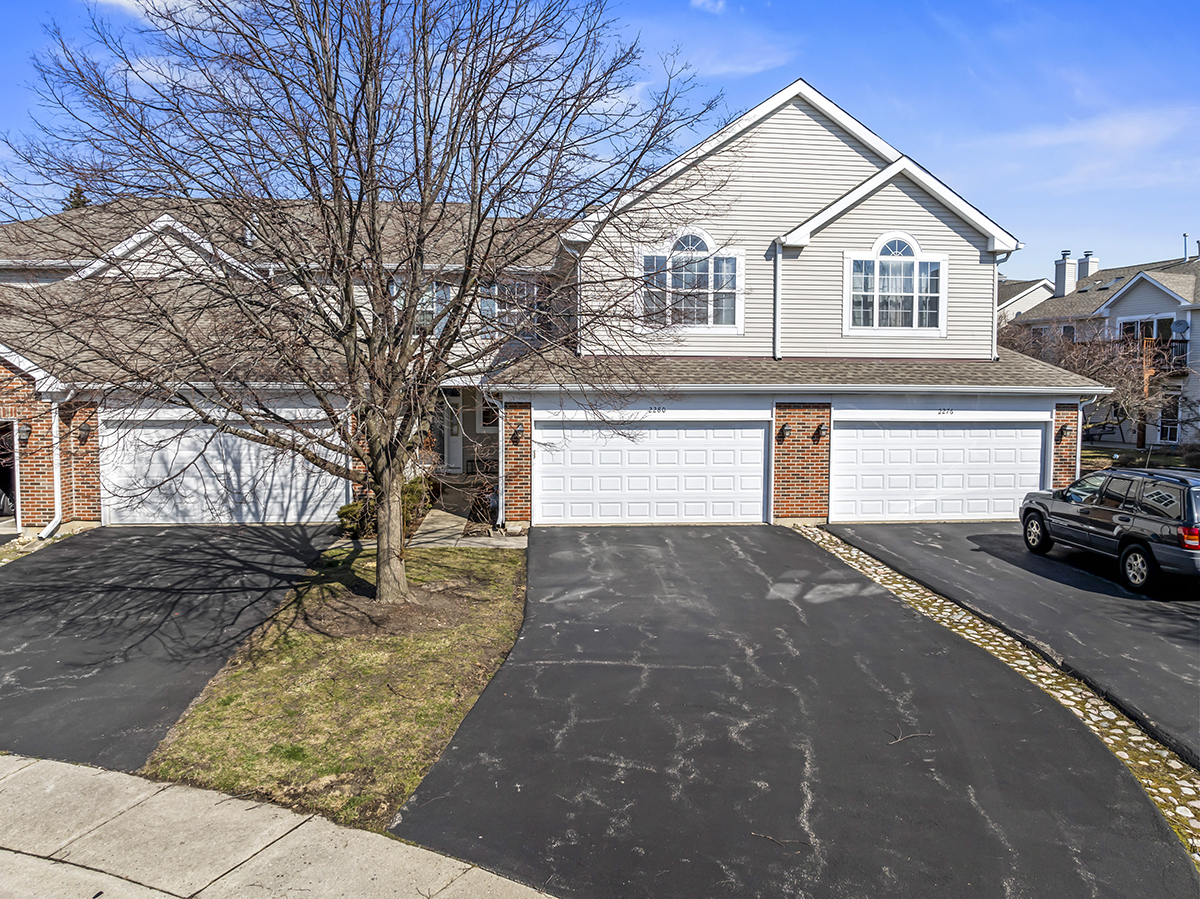 2280 Briar Court Hoffman Estates, IL 60169 - Photo 2 of 36 a front view of a house with a yard and garage