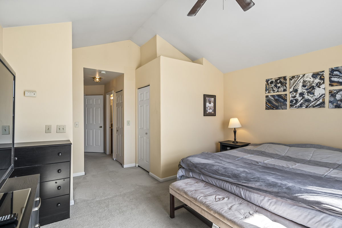 2280 Briar Court Hoffman Estates, IL 60169 - Photo 21 of 36 a bedroom with a bed and a chandelier