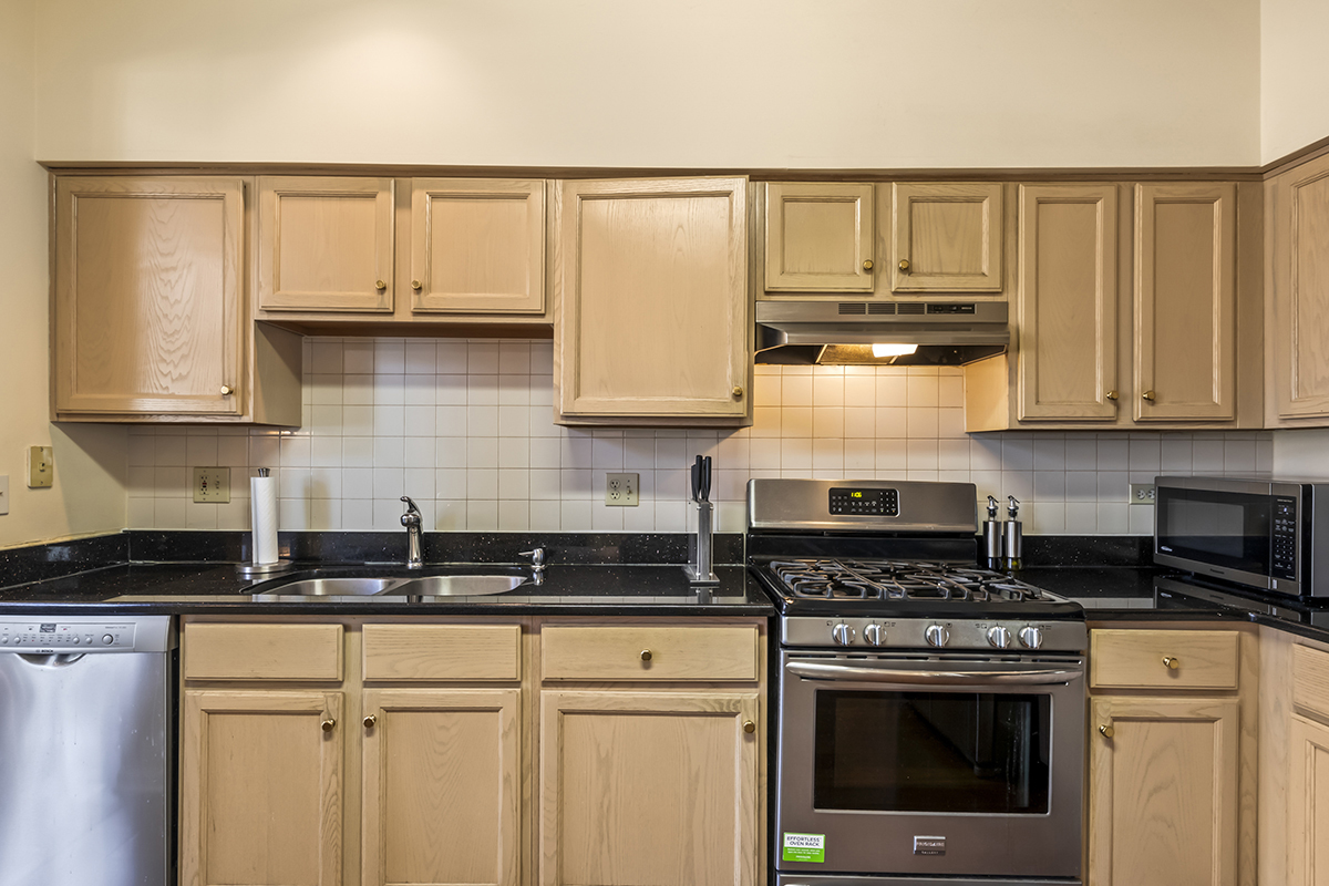 2280 Briar Court Hoffman Estates, IL 60169 - Photo 8 of 36 a kitchen with stainless steel appliances granite countertop a stove and cabinets