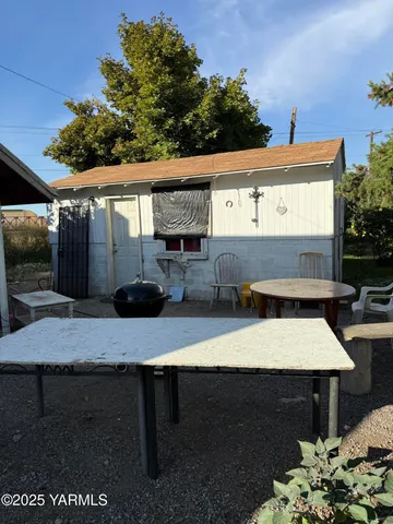 a view of a patio with table and chairs with potted plants
