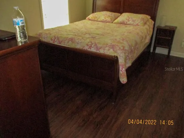 a bed sitting in a bedroom next to a bathroom