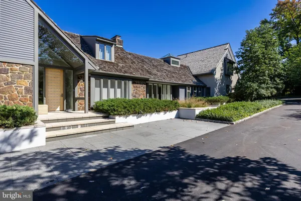 a front view of a house with a yard and outdoor seating