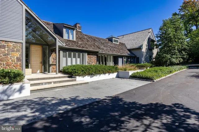 a front view of a house with a yard and outdoor seating