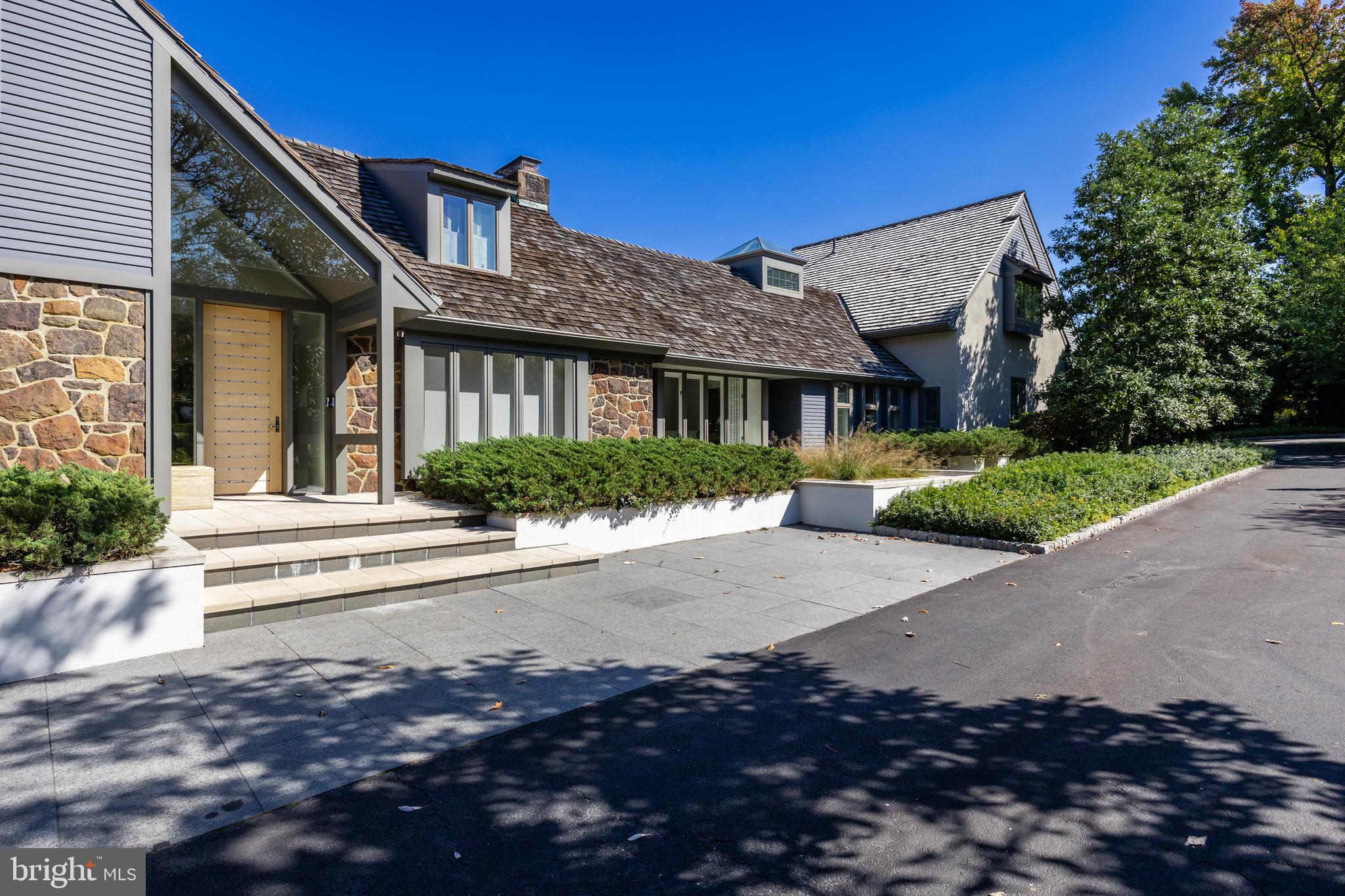a front view of a house with a yard and outdoor seating