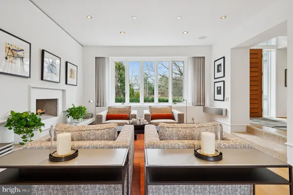 a dining room with furniture and a floor to ceiling window