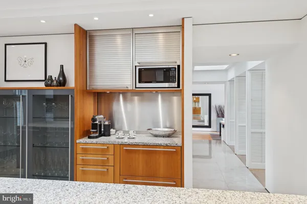 a bedroom with a bed and a flat tv screen on dresser