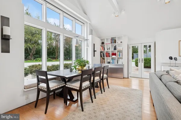 a view of swimming pool with chairs in wooden floor