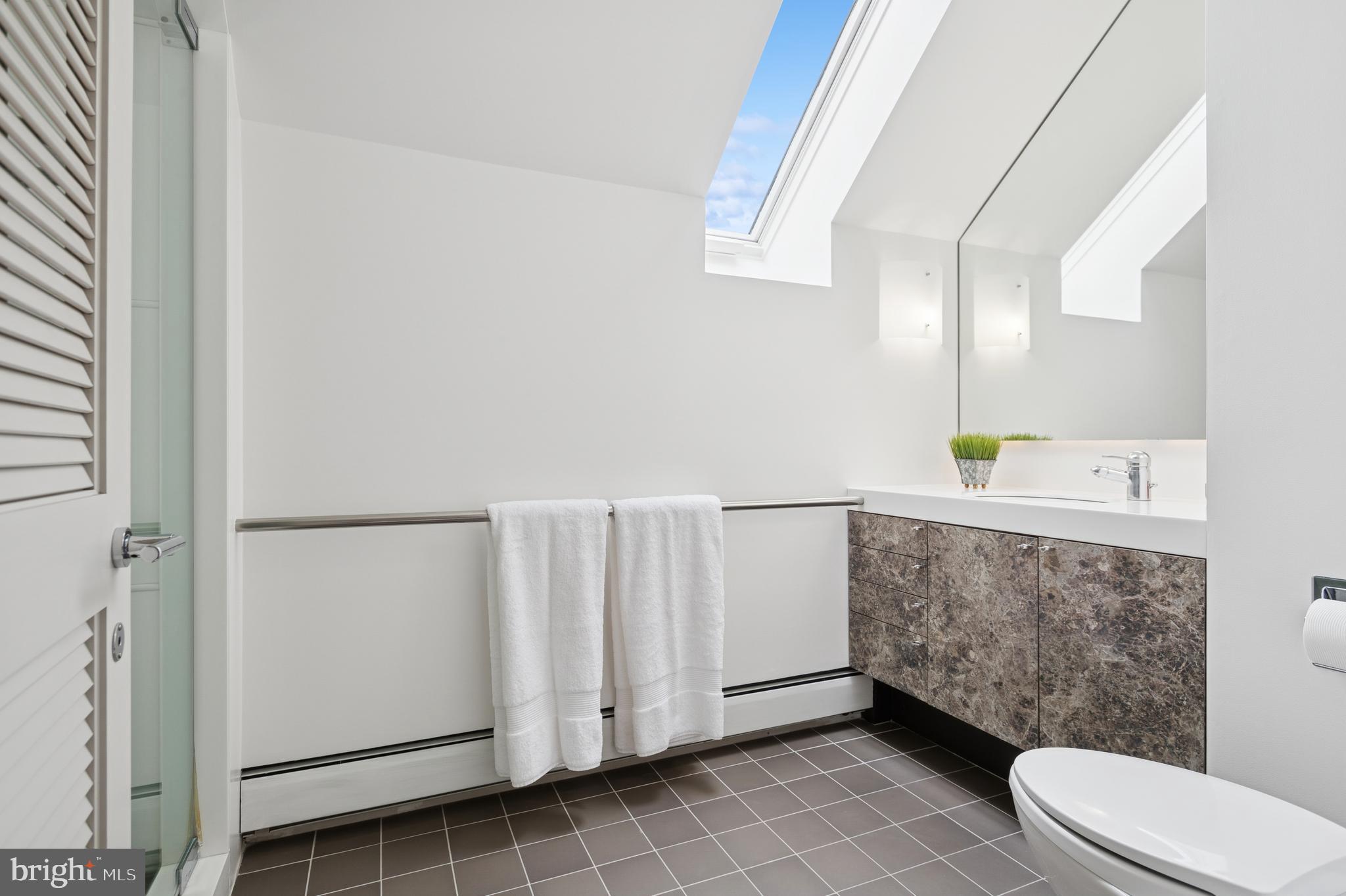 95 Lane Of Acres Haddonfield, NJ 08033 - Photo 50 of 114 a bathroom with a toilet a sink and mirror