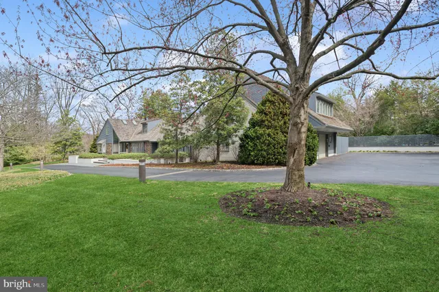 a view of a house with a garden and parking