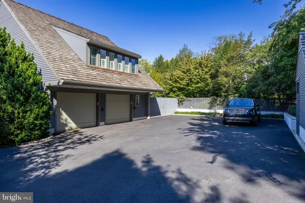 an aerial view of a house with a yard and lake view