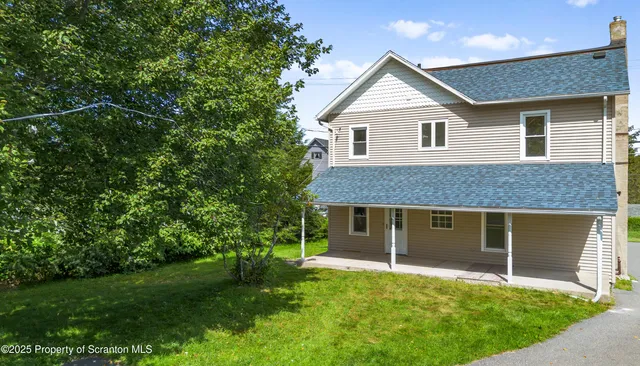 a front view of a house with a garden and yard