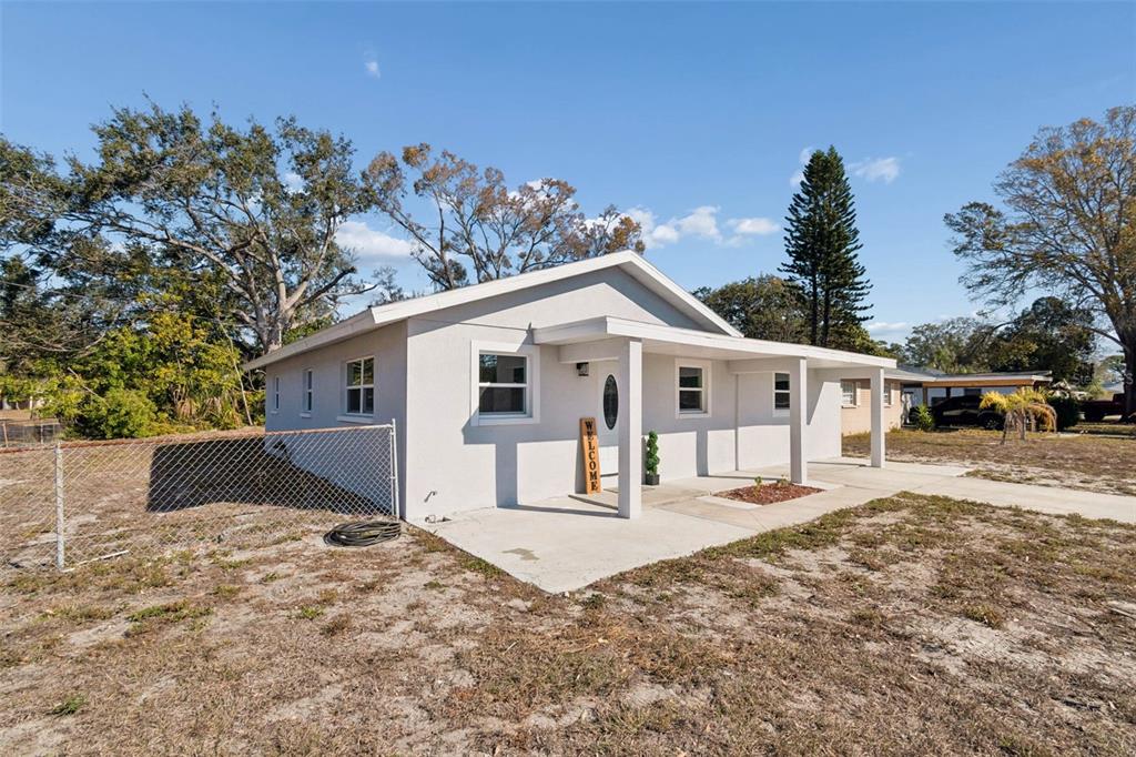 7097 Delta Way Clearwater, FL 33764 - Photo 12 of 71 a front view of a house with a yard covered in snow