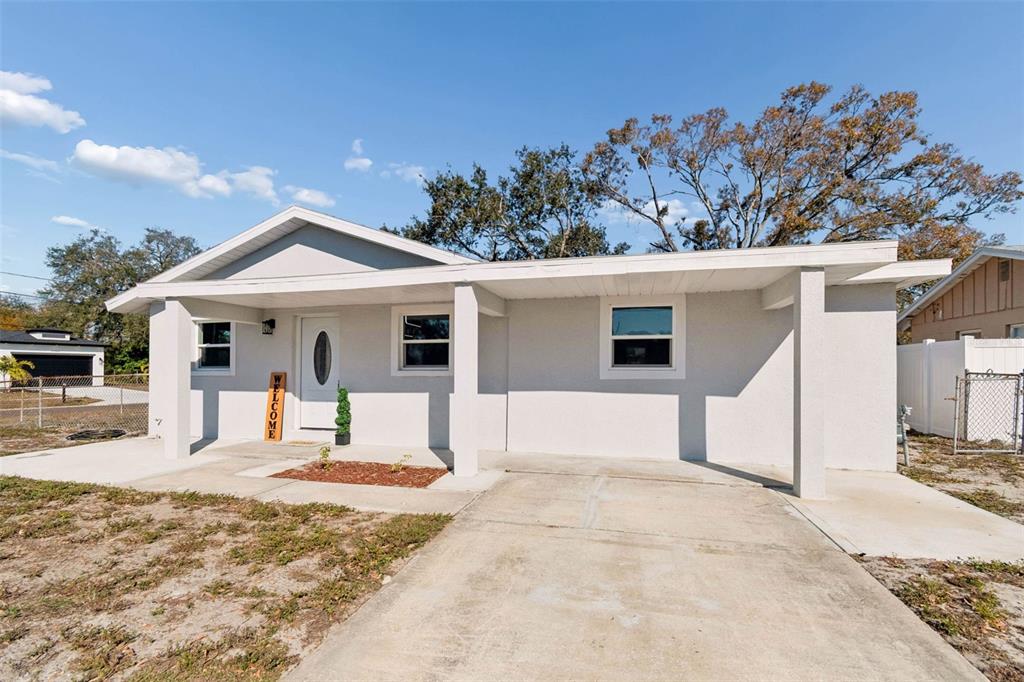 7097 Delta Way Clearwater, FL 33764 - Photo 13 of 71 a front view of a house with a yard outdoor seating and covered with snow in front of it