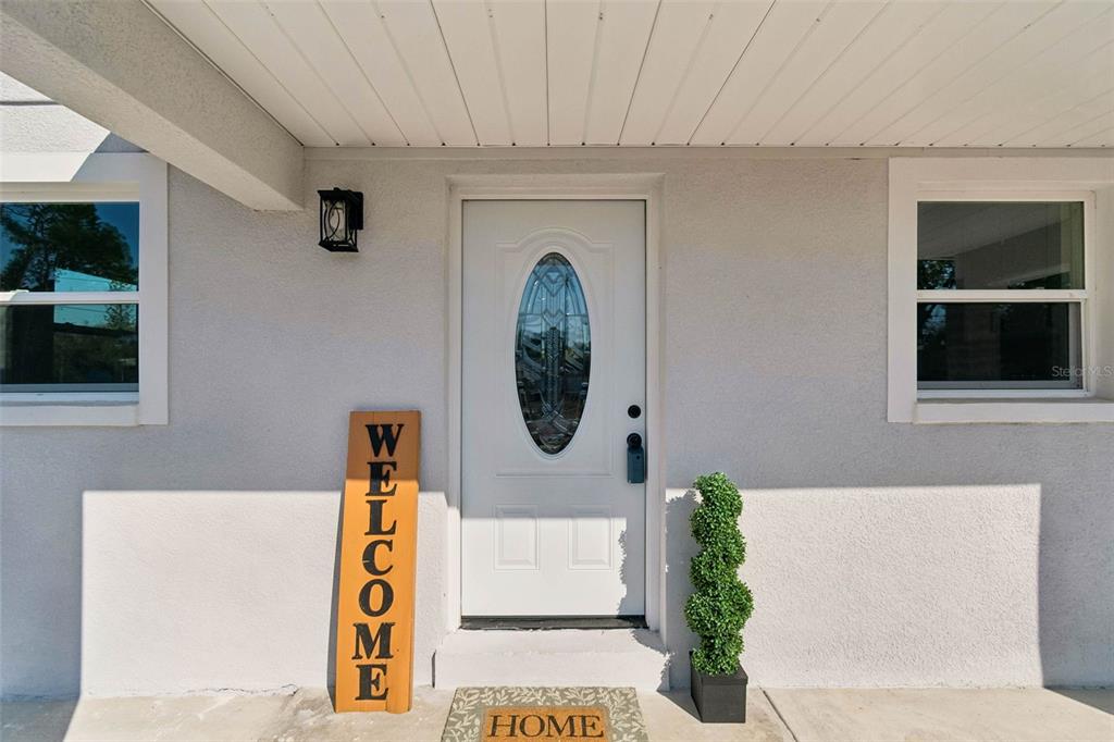 7097 Delta Way Clearwater, FL 33764 - Photo 16 of 71 a front view of a house with entryway