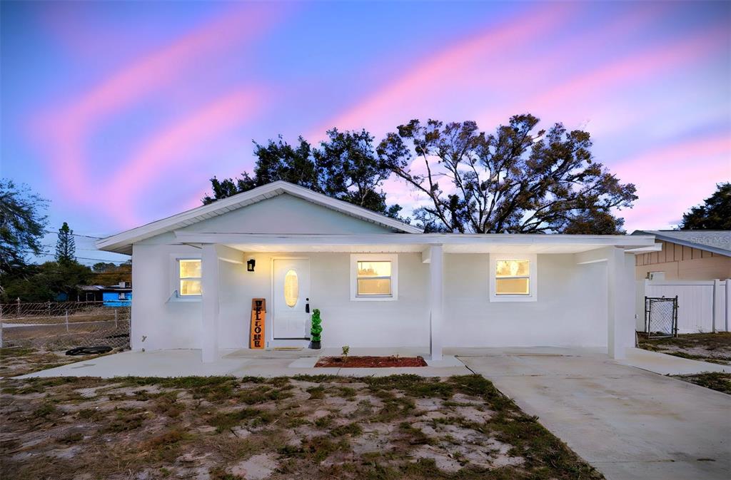 7097 Delta Way Clearwater, FL 33764 - Photo 2 of 71 a front view of a house with a yard and garage
