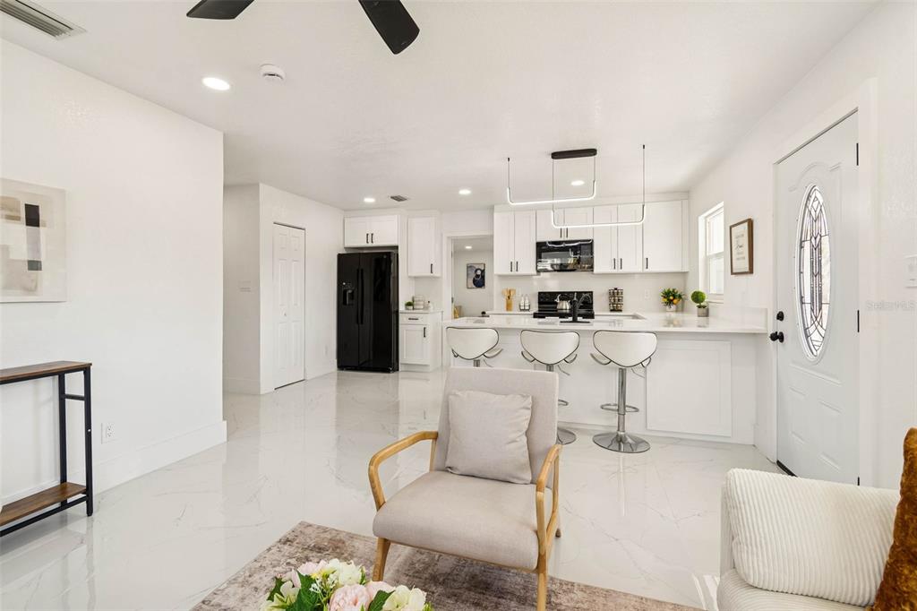 7097 Delta Way Clearwater, FL 33764 - Photo 21 of 71 a living room with stainless steel appliances furniture a flat screen tv and a window