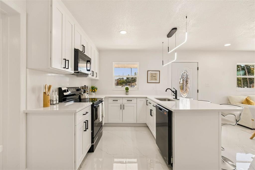7097 Delta Way Clearwater, FL 33764 - Photo 24 of 71 a kitchen with stainless steel appliances granite countertop a sink and cabinets